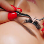 Eyelash Extension Procedure. Woman Eye with Long Eyelashes. Lashes. Close up, macro, selective focus