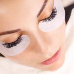 Eyelash Extension Procedure. Woman Eye with Long Eyelashes. Lashes. Close up, macro, selective focus